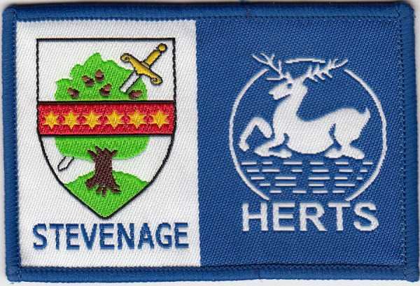 [Stevenage @ District Badge]