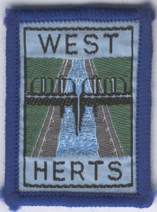[West Herts District Badge]