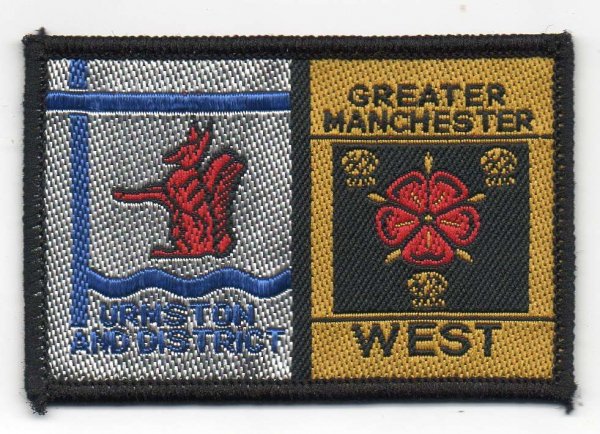 [Urmston And District @ District Badge]